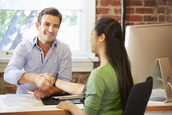 42307596 - businessman interviewing female job applicant in office